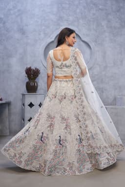 Ivory Soft Net Sangeet Lehenga With Peacock Motifs